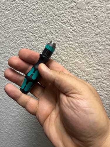 Reviewer holding the small Wera Bitholding screwdriver in their hand to show its size.