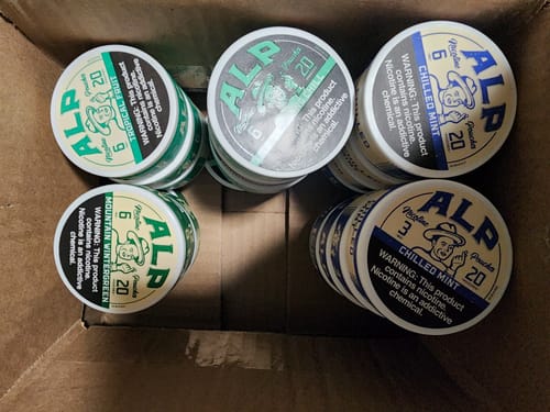 Customer's large order showing stacks of Chilled Mint Nicotine Pouches and other flavors in a box.