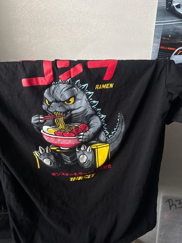 A customer's black RAMEN MONSTER TEE, showing the centered graphic of a monster eating ramen.