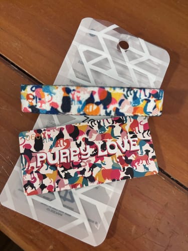 Customer's colorful Puppy Love Bracelet shown with its packaging card that reads 'PUPPY LOVE'.