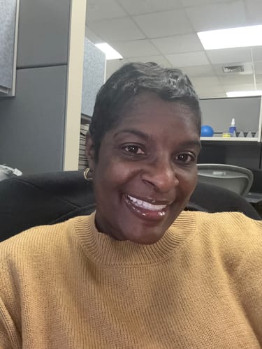 A reviewer's selfie showing their glowing face, a result of the products from the Glo Melanin Travel Bag.