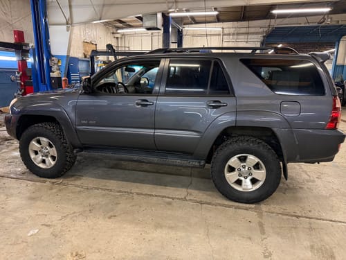 Customer's gray Toyota 4Runner in a garage, showing its wider stance after installing 1-inch wheel spacers.