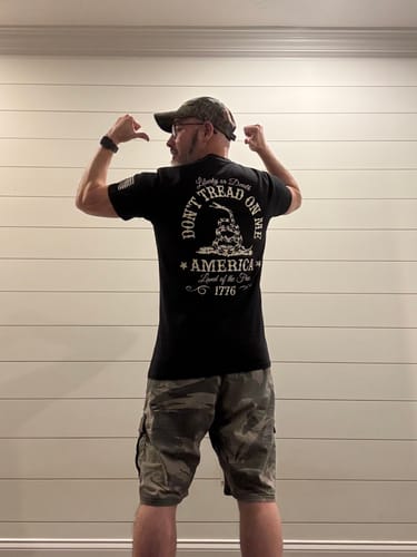 Reviewer seen from behind, wearing the black DON'T TREAD ON ME TEE and showing the back graphic and fit.