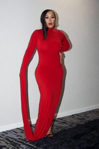 Reviewer posing in the sleek, red Naked Draped Sleeve Maxi Dress indoors.