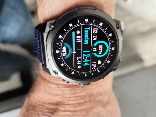 Reviewer's rugged Ultra 3 smart watch on their wrist, showing a detailed digital face with activity data.
