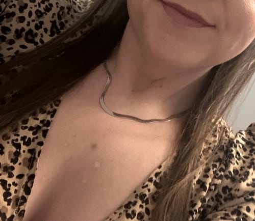 Close-up of a reviewer wearing the silver-colored Essentials Snake Chain Necklace on their collarbone
