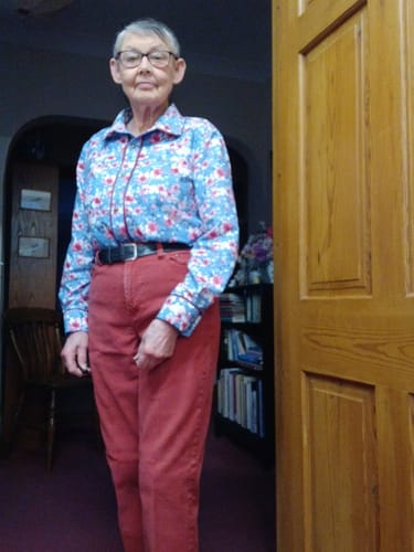 Customer wearing a long-sleeved blouse made from the blue blossom printed cotton.