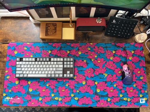 Customer's colorful Cyber Lotus desk mat on a desk with a keyboard and mouse.