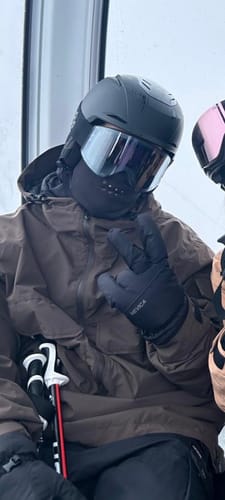 Reviewer on a ski lift wearing the coffee-colored Snow Anorak.
