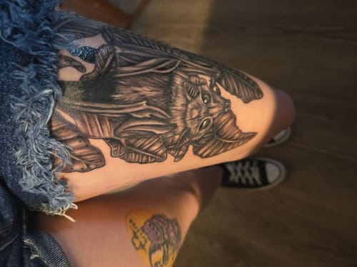 Reviewer shows a large bat tattoo on their thigh, done after using Painless Tattoo Numbing Cream.