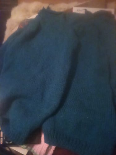 Customer's finished Blue Hour Cardigan in a dark teal color, knitted from the provided yarn.