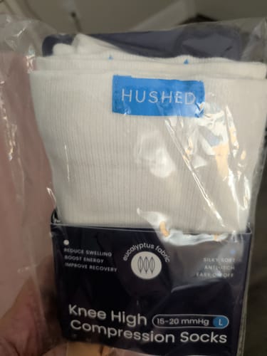 Customer's white Performance Eucalyptus Compression Socks shown in their original, unopened packaging.