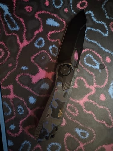 Customer's Remette Peregrine Falcon knife showing its blackout blade and patterned camo carbon handle.