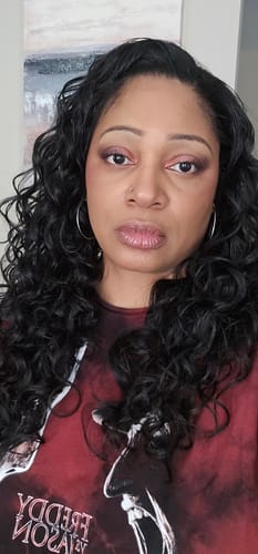 Reviewer from the front wearing the Outre CURL HAVEN half wig, showing the long, soft spiral curls.