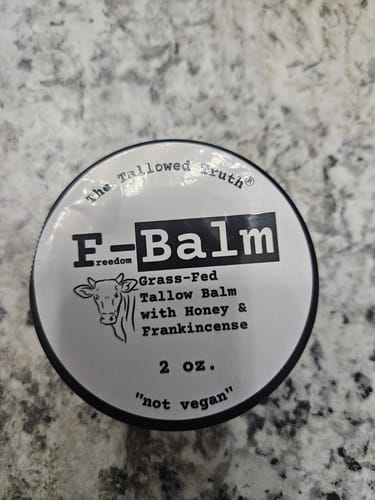 Customer's overhead view of the F-Balm jar, showing the full label on a granite countertop.