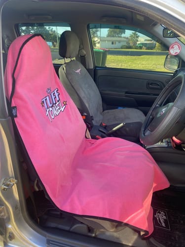 Customer's bright pink Waterproof Car Towel Seat Cover fitted on the driver's seat of a car.