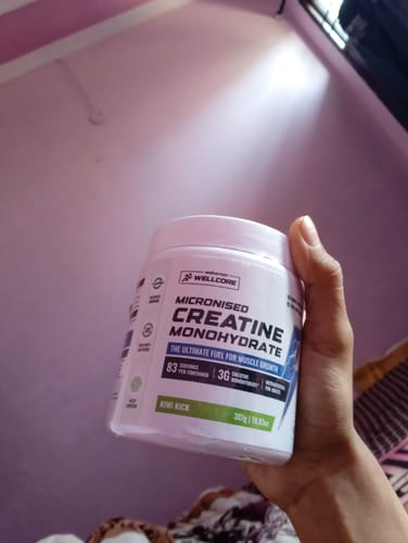 Customer holding the white tub of Wellcore Micronised Creatine Monohydrate.