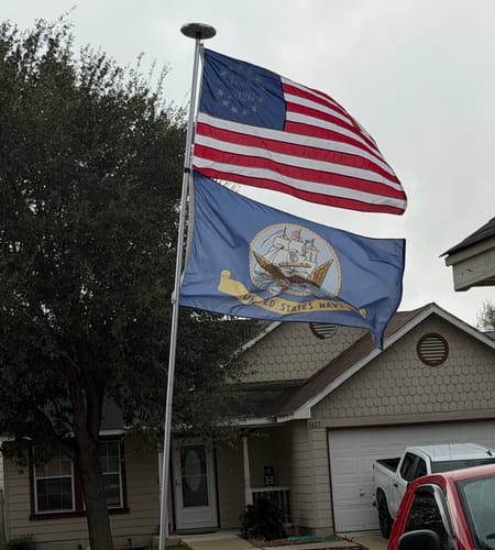 Customer's 1776 to 2026 Betsy Ross Flag flying on a flagpole outside a house.