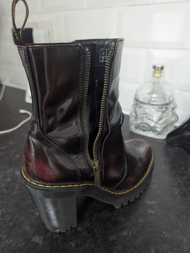 Customer's image of a shiny, burgundy heeled boot with a partially unzipped side.