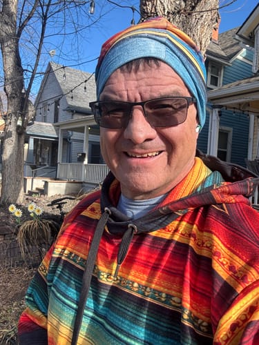 Reviewer smiling outdoors in the colorful Michoacán Cultura Hoodie.