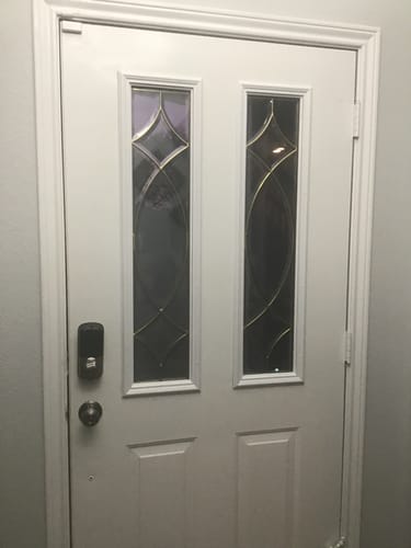 Customer's installed Half Sidelite Frame Kit on a white door with two decorative glass panels.