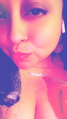 Close-up of a reviewer wearing the silver-toned Chicana Amor Chain necklace.