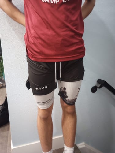Reviewer wearing the two-layer Soldier's Faith Performance Shorts with a black outer layer and white printed inner layer.