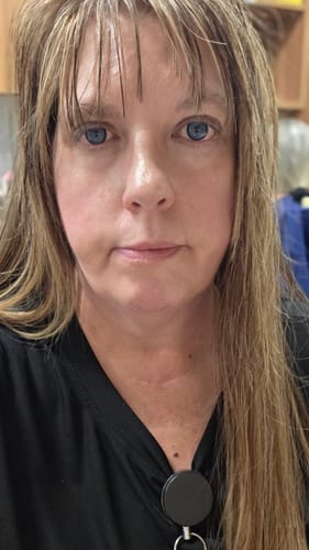 Close-up of a reviewer wearing the vibrant Norko Blue prescription colored contact lenses.
