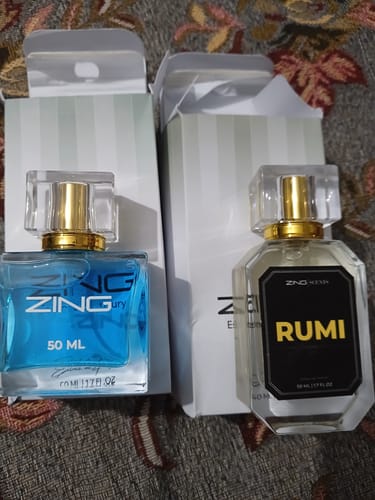 Customer's two perfumes, a blue 'Zing Fury' and a clear 'Rumi', displayed in front of their packaging.