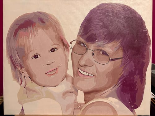 Reviewer's finished custom paint by numbers kit, showing a portrait of an adult and child.