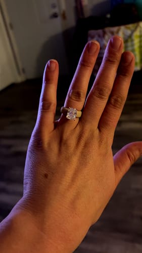 Customer's hand wearing the comfortable Silicone Ring with a large emerald-cut CZ stone.
