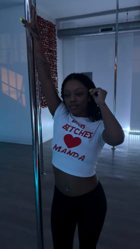 Reviewer in a studio wearing black Seamless LowRise Leggings while holding a pole.