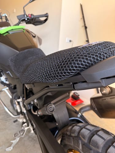 Customer's black mesh Wind Rider Seat Cover fitted onto the seat of their motorcycle, viewed from the rear side.