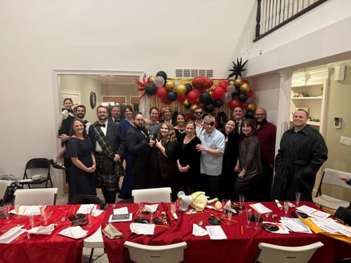 Reviewers and their guests in character costumes for a fun James Bond Spy Murder Mystery party.