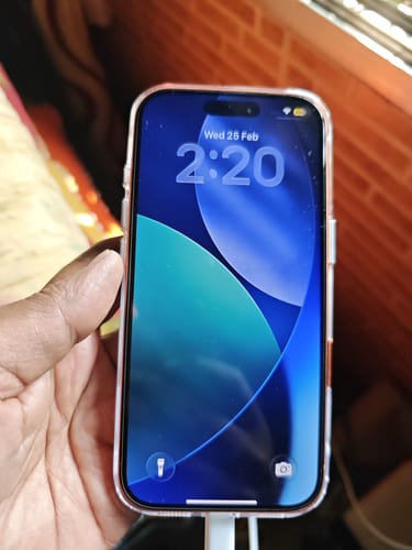 Customer holding a smartphone with the UltraShield Tempered Glass perfectly applied to the screen.