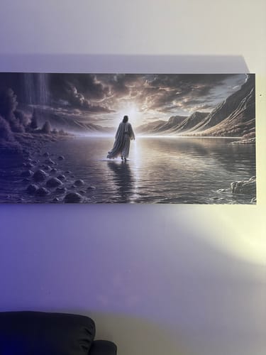Reviewer's 'Walking on Water - Faith Wall Art II' canvas hung on a wall in their home.