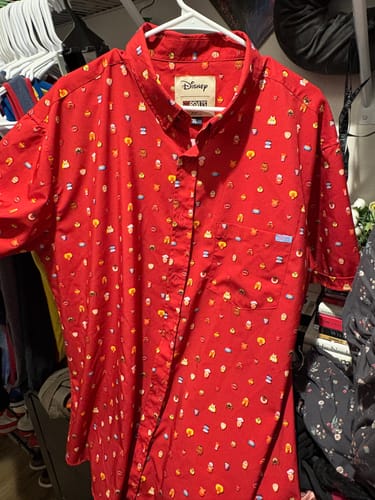 Reviewer's red "Lil Muppets" shirt on a hanger, showing the all-over print of Muppet characters.