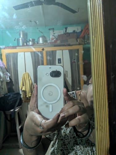 Reviewer's mirror selfie showing the clear Anti Yellow Magsafe case on their phone.