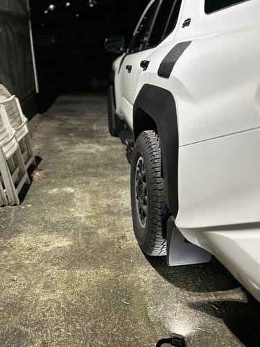 Customer's white truck at night, showing the wider stance from the installed 1.5 inch forged wheel spacers.