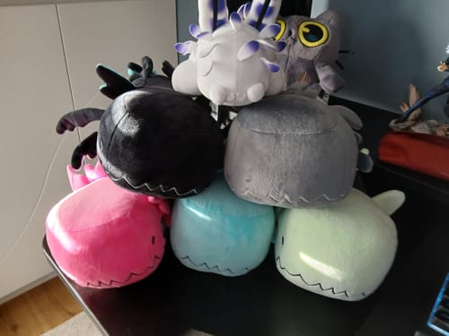 Customer's Glowing Pink Lizard Plush in a large pile with other plushies from the Rain World collection.