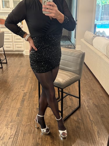 Reviewer wearing the sheer black PLAY - FREE HUGGING SEAMLESS TIGHTS with a short, black sequin dress.
