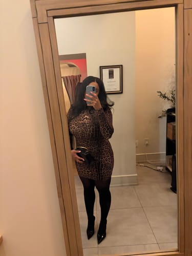 Reviewer's mirror selfie showing the front of the fitted, long-sleeved Naked Print Mini Dress.