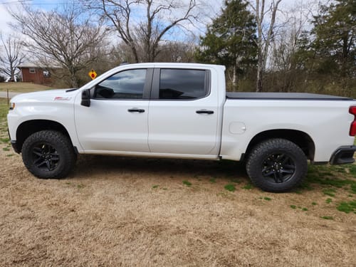 Customer's white Chevy Silverado Trailboss with a level stance after installing the 2" front leveling lift kit.