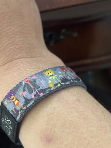 Customer wearing the Let The Music Play Fraggles Bracelet, showing a close-up of the colorful character design.