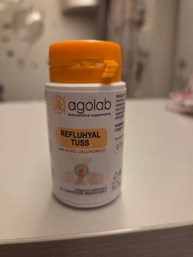Recensore mostra la confezione di Refluhyal Tuss con tappo arancione.