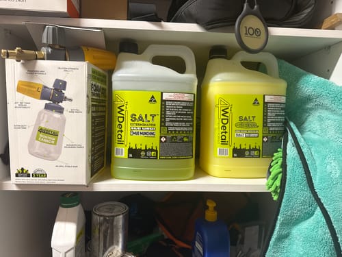 Customer's full kit, including Salt Seal™ and Salt Exterminator™ jugs, on a shelf next to a foam cannon box.