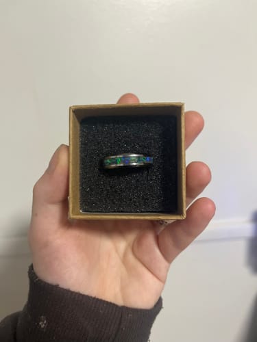 Reviewer's Tungsten Opal Ring with a colorful inlay, nestled in its presentation box.