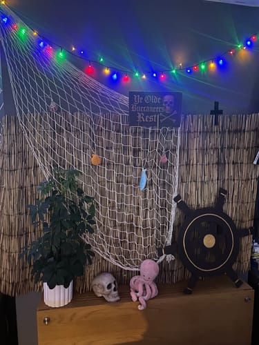 Customer's pirate-themed decorations for their murder mystery game, featuring a net, skull, and ship's wheel.