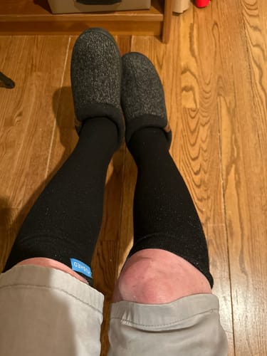 Customer wearing the black Performance Eucalyptus Compression Socks, showing the snug fit from knee to ankle.