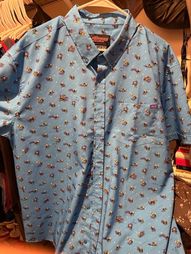 Reviewer's blue 'I AM MOJO JOJO' shirt on a hanger, showing the all-over print of the character in different poses.